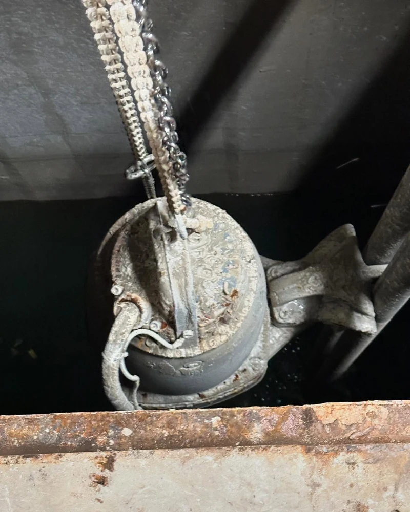 Submerged pump being removed for maintenance services.