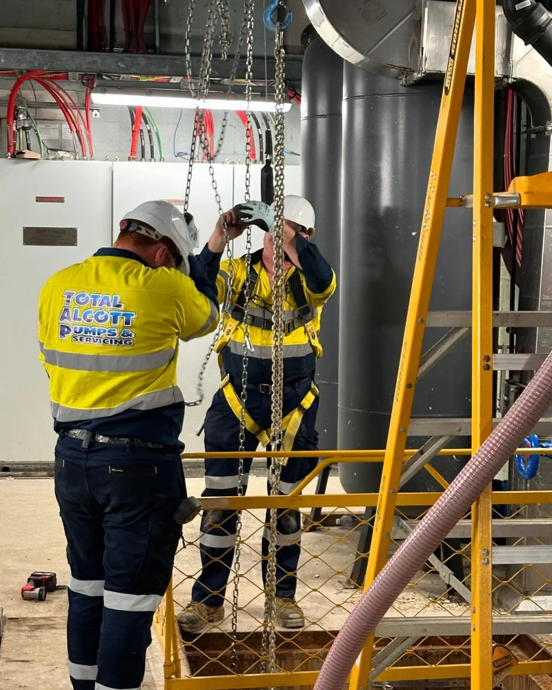 Total Alcott Pumps & Servicing technicians working on a commercial installation job.
